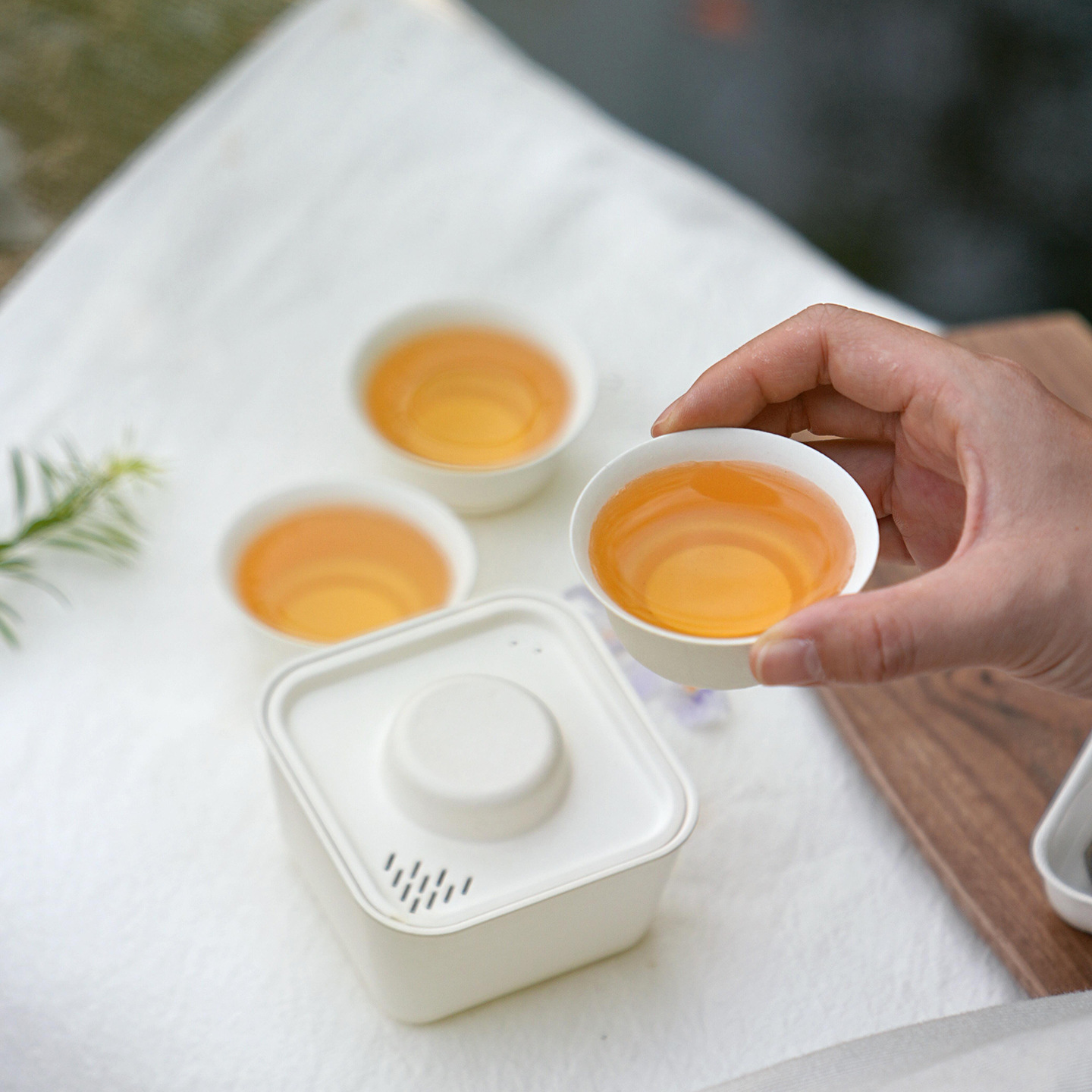 Three cups serving tea from a portable set